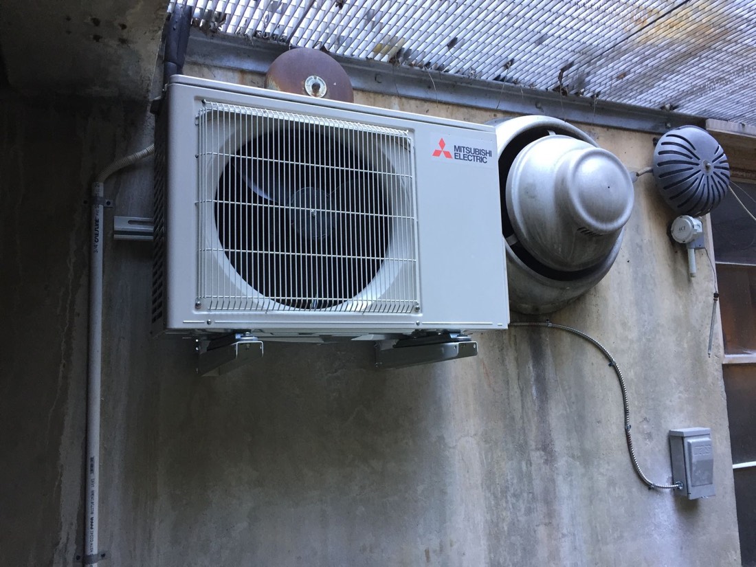 Mitsubishi Electric outdoor unit in a commercial mechanical space